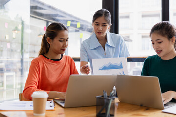 group of asian businesswoman working on laptop with finances analysis report at desk in office, business financing, accounting banking, Team of creative and business planning, 