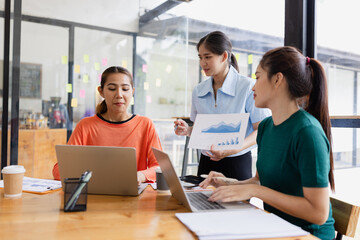 group of asian businesswoman working on laptop with finances analysis report at desk in office, business financing, accounting banking, Team of creative and business planning, 