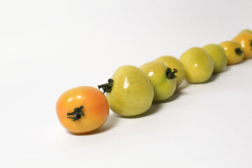 Little green tomatoes on isolated white background
