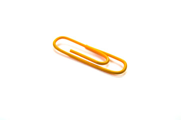 Orange paper clip isolated on white background. close up