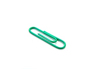 Green paper clip isolated on white background. close up