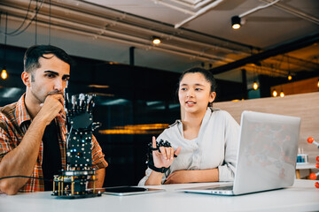 In a classroom teacher helps student build robotic arm for design and technology. Encouraging innovation discovery and coding skills in science education. Robot hand. Innovation and technology concept