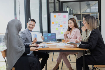 Team of Asian business people and working together in office, Startup projects and business presentation at meeting room.