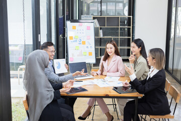 Team of Asian business people and working together in office, Startup projects and business presentation at meeting room.