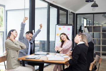 Team of Asian business people and working together in office, Startup projects and business presentation at meeting room.