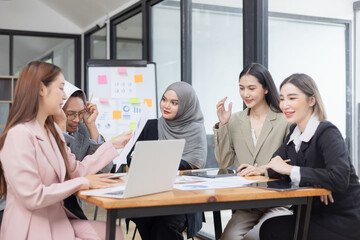 Team of Asian business people and working together in office, Startup projects and business presentation at meeting room.