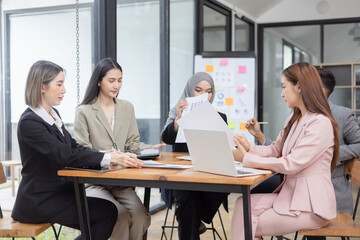 Team of Asian business people and working together in office, Startup projects and business presentation at meeting room.
