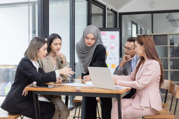Team of Asian business people and working together in office, Startup projects and business presentation at meeting room.
