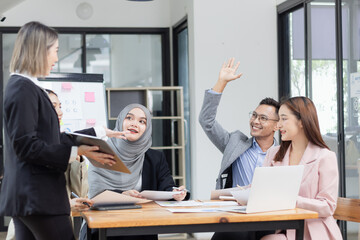 Team of Asian business people and working together in office, Startup projects and business presentation at meeting room.