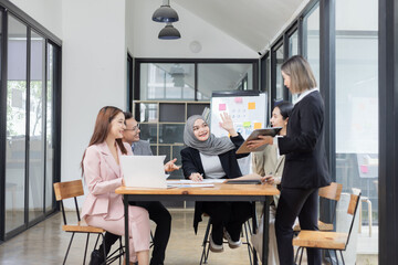 Team of Asian business people and working together in office, Startup projects and business presentation at meeting room.