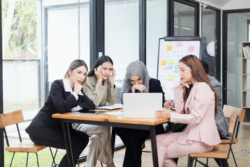 Fototapeta premium Team of Asian business people and working together in office, Startup projects and business presentation at meeting room.
