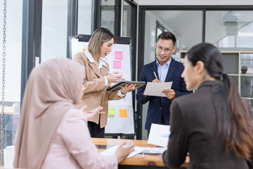 Team of Asian business people and working together in office, Startup projects and business presentation at meeting room.