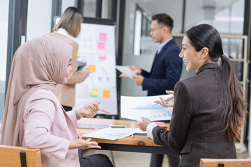 Team of Asian business people and working together in office, Startup projects and business presentation at meeting room.
