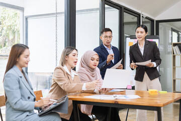 Team of Asian business people and working together in office, Startup projects and business presentation at meeting room.