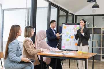 Team of Asian business people and working together in office, Startup projects and business presentation at meeting room.