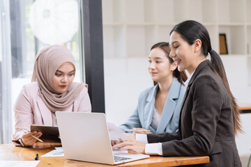 Obraz premium Team of Asian business people and working together in office, Startup projects and business presentation at meeting room, Brainstorming and business,