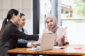 Obraz premium Team of Asian business people and working together in office, Startup projects and business presentation at meeting room, Brainstorming and business,