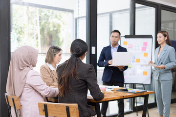 Team of Asian business people and working together in office, Startup projects and business presentation at meeting room.