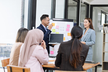 Team of Asian business people and working together in office, Startup projects and business presentation at meeting room.