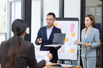 Team of Asian business people and working together in office, Startup projects and business presentation at meeting room.
