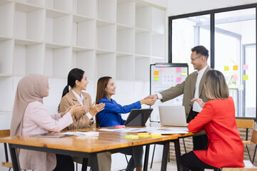 Asian business teamwork making handshake with partner in meeting room, Greeting and corporate business handshake, 