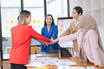 Asian business teamwork making handshake with partner in meeting room, Greeting and corporate business handshake, 