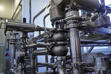 Metal pipes with different fasteners at the factory.