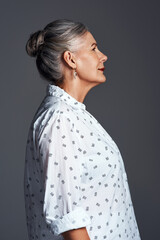 Studio, fashion and profile of mature woman with thinking, confidence and creative inspiration....