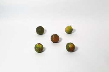 Green lime fruits on isolated white background. Sliced and unsliced.