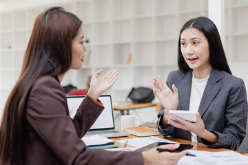 Asian businesswoman working on laptop with finances analysis report at desk in office, business financing, accounting banking,