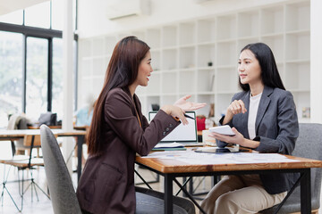 Asian businesswoman working on laptop with finances analysis report at desk in office, business financing, accounting banking,