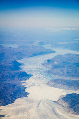 Greenlandic ice cap with frozen mountains and glacier aerial view