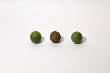 Green lime fruits on isolated white background. Sliced and unsliced.