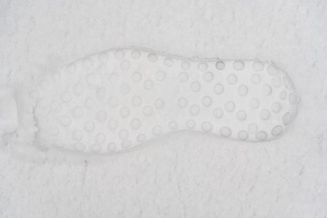 Shoe prints on white snow. footprints in snow. close up. top view.
