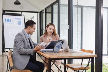 Two business people working with business financing accounting banking and laptop with finances...