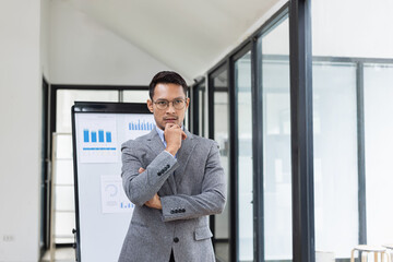 Fototapeta premium Happy asian businessman standing in office, Excited male person, Employee in achievement,&nbsp;