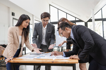 Asian business teamwork working with analysis report and advisor showing plan, Financial analysis and Marketing teamwork concept.
