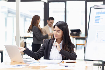 Asian businesswoman working at desk in office, Business accounting concept,