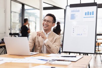 Happy asian businessman working with business financing accounting banking and laptop with finances...