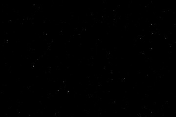 Chaotic white star bokeh on black background. falling blurry bokeh snow overlay, starry sky. white spot and drops. abstraction