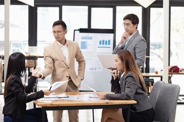 Asian business teamwork working with analysis report and advisor showing plan, Financial analysis and Marketing teamwork concept.