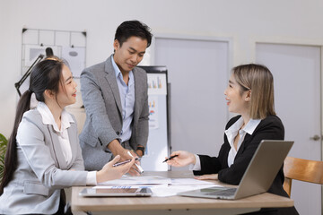 Asian business teamwork working on digital tablet with analysis report and advisor showing plan, Financial analysis and Marketing teamwork concept.