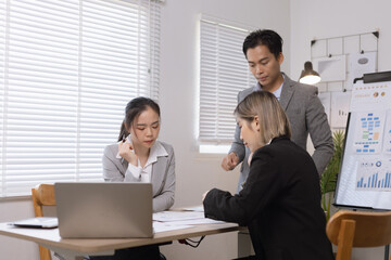 Asian business teamwork working on digital tablet with analysis report and advisor showing plan, Financial analysis and Marketing teamwork concept.