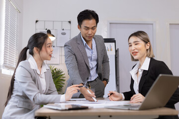 Asian business teamwork working on digital tablet with analysis report and advisor showing plan, Financial analysis and Marketing teamwork concept.