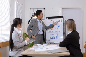 Asian business teamwork working on digital tablet with analysis report and advisor showing plan, Financial analysis and Marketing teamwork concept.