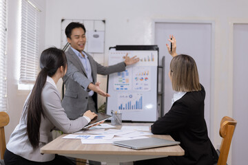 Asian business teamwork working on digital tablet with analysis report and advisor showing plan, Financial analysis and Marketing teamwork concept.