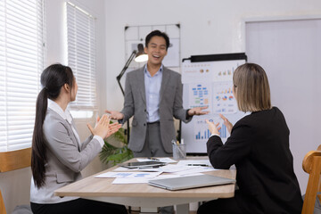 Asian business teamwork working on digital tablet with analysis report and advisor showing plan, Financial analysis and Marketing teamwork concept.