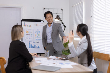 Asian business teamwork working on digital tablet with analysis report and advisor showing plan, Financial analysis and Marketing teamwork concept.