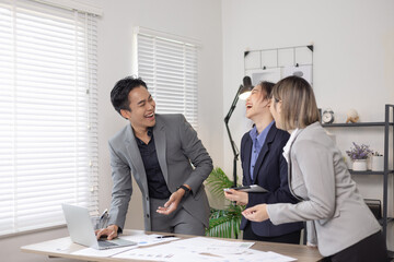 Asian business teamwork working on digital tablet with analysis report and advisor showing plan, Financial analysis and Marketing teamwork concept.