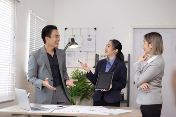 Asian business teamwork working on digital tablet with analysis report and advisor showing plan, Financial analysis and Marketing teamwork concept.